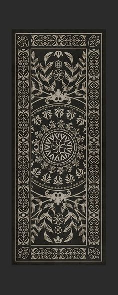 a black and white rug with an ornate design on the bottom, surrounded by decorative elements