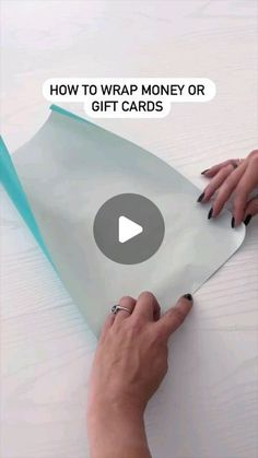 someone is wrapping money or gift cards on a table with the text how to wrap money or gift cards