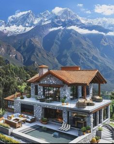 an aerial view of a house with mountains in the background