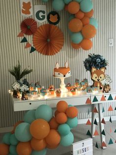 a table topped with lots of balloons and decorations