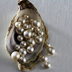 an open oyster shell with pearls in it