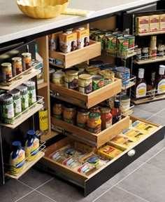 an organized kitchen pantry with lots of food in the drawers and spices on the shelves