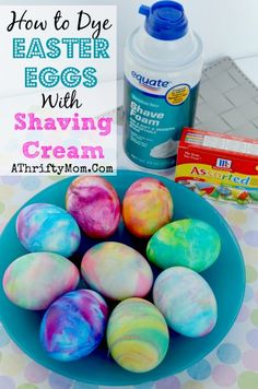 easter eggs with shaving cream on a blue plate next to an egg carton