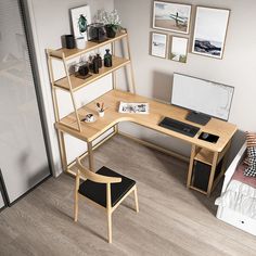 a computer desk sitting on top of a hard wood floor next to a white wall