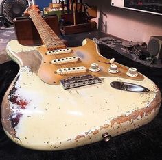 an old guitar sitting on top of a table