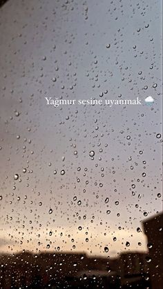 rain drops on the window and sky in the background with words that read, vaginar seisine nyernmak