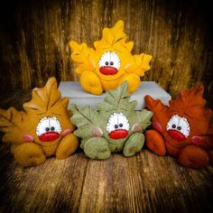 four stuffed animals sitting on top of a wooden table