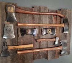 an assortment of hammers mounted to a wooden wall