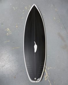 an upside down surfboard on the ground