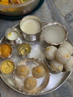 a silver plate topped with different types of food