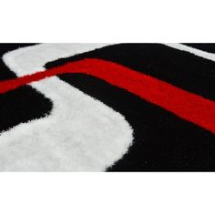 a black and white rug with red stripes