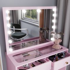 a pink vanity with lights on it and a chair