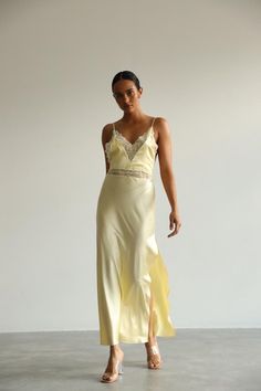 This long white Slip Dress made of soft pure mulberry silk. A V-neckline with lace, open back with adjustable spaghetti straps, meet a bias cut to fall beautifully against the body, inspiring a feminine silhouette. Effortless for both day and night, for romantic evening or as a bridal getting ready dress.   Model is 168 cm, 84/64/89 wears size XS Total length 135 cm from the shoulder  Off white color Spring Silk Slip Dress With Delicate Lace, Elegant Lace Slip Dress With V-neck, Elegant Lace V-neck Slip Dress, Elegant V-neck Slip Dress With Lace Back, Spring Delicate Lace V-neck Slip Dress, Chic Wedding Slip Dress With Lace Trim, Silk Sleeveless Slip Dress With Delicate Lace, V-neck Slip Dress With Delicate Lace For Party, Elegant Lace Slip Dress With Delicate Straps