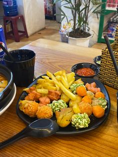 there are many different types of food on the table, including fries and other foods