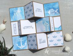 some cards are stacked on top of each other with an anchor and fish stamping