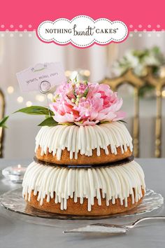 a cake with white icing and pink flowers on top