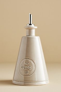 a white ceramic bottle with the word ouo written on it