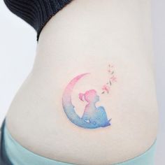 a woman with a tattoo on her stomach holding a flower in the shape of a moon