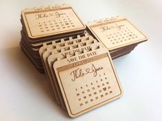 wooden save the date magnets are stacked on top of each other with calendar designs