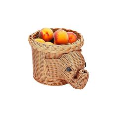 a wicker basket filled with peaches on top of a white background in the shape of an elephant