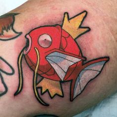 a close up of a person's arm with a tattoo on it and an image of a fish