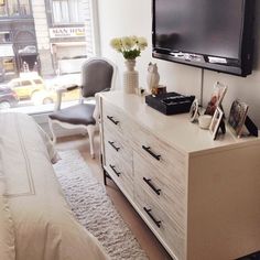 a bedroom with a large flat screen tv mounted on the wall