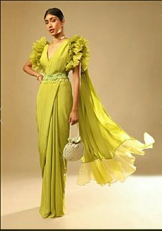 Looking for an elegant yet chic look, this lime green georgette saree with elaborate ruffle sleeved crop top and heavy stone embroidered belt is best pick for you. Lime Green Saree, Baju Kahwin, Sleeved Crop Top, Embroidered Belt, Designer Saree Blouse Patterns, Stylish Blouse Design