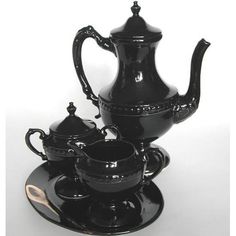 a black tea set with matching saucers and cups