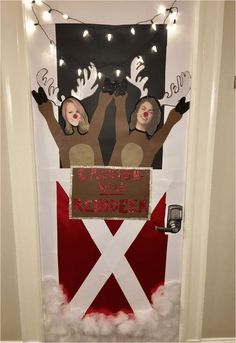 a door decorated to look like two women in reindeer costumes