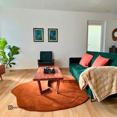 a living room filled with furniture and a wooden table on top of a hard wood floor