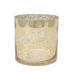 a glass candle holder with gold speckles on the outside and inside, sitting on a white surface