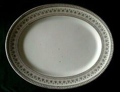 an empty white plate on a black background