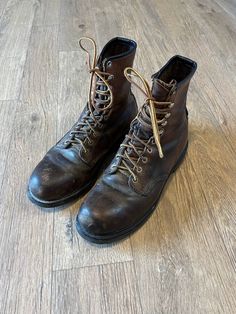 Vintage Red Wing Boots in gently used condition. Men's 9 1/2 B. Steel toe and non slip, perfect for work or industrial fashion. They are a dark brown leather. They are tall and lace up with brown and yellow laces. On the outside of the tongue of the left boot is marked Leather upper, PO, 9 1/2 B, 24205. Inside the tongue on the right boot is the Red Wing tag, marked made in USA. On the upper shaft of the right boot it's stamped Red Wing 08 90. Gently used, leather has some scuffs and fading, see Sturdy Work Boots With Round Toe, Sturdy Leather Work Boots, Rugged Brown Closed Toe Work Boots, Brown Round Toe Work Boots, Classic Sturdy Boots With Round Toe, Classic Sturdy Work Boots With Round Toe, Brown Round Toe Work Boots For Workwear, Vintage Plain Toe Workwear Boots, Slip-resistant Plain Toe Brown Boots