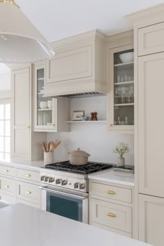 a kitchen with white cabinets and an oven