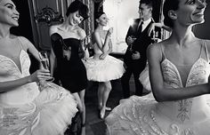 four ballerinas in tutu skirts are posing for the camera with their champagne flutes