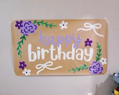 a happy birthday sign hanging on the wall