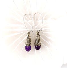 Tibetan amethyst silver earrings. Antique silver dangle earrings with gorgeous purple amethyst.  Ear wires are antique silver. Lightweight and comfortable to wear, 2.00" x .25".  See matching bracelets below. *SIZE* Length is 2.00 inches Width is .25 inches *FREE SHIPPING* I will get your lovely in the mail within 24 to 48 hours.  Shipping is Monday through Friday and mailed USPS first class or priority mail. Tracking number will be sent to you. *MATCHING BRACELETS*: https://www.etsy.com/listing/1584152290 For more delights from Mystic Pieces: Silver Earrings: https://www.etsy.com/shop/mysticpieces?ref=seller-platform-mcnav&section_id=31828678 Bracelets: https://www.etsy.com/shop/mysticpieces?ref=profile_header&section_id=39102386 Back to Mystic Pieces Home Store: https://www.etsy.com/shop Vintage Amethyst Purple Earrings, Handmade Amethyst Purple Earrings, Purple Sterling Silver Teardrop Dangle Earrings, Purple Crystal Earrings With Ear Wire As Gift, Nickel Free Purple Crystal Drop Earrings, Purple Amethyst Drop Teardrop Earrings, Spiritual Amethyst Drop Earrings, Purple Pierced Crystal Earrings As Gift, Purple Drop Crystal Earrings Nickel Free