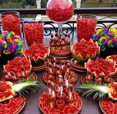 a table topped with watermelon slices and candy