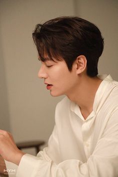 a young man sitting at a table eating food