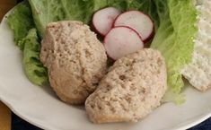 a white plate topped with lettuce and radishes