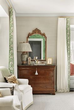 a living room filled with furniture and a large mirror on top of a wooden dresser