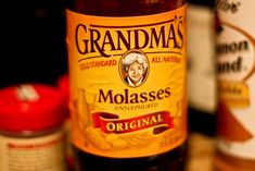 a bottle of grandma's molassses sits next to other bottles on a table