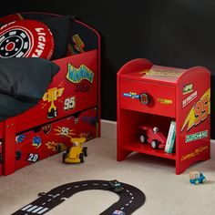 two children's beds with cars on them and a race track in the middle