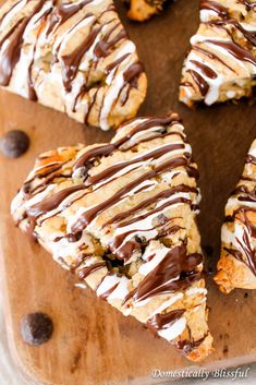 chocolate drizzled cookies are arranged on a cutting board with one cookie cut in half