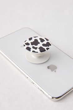 a cell phone with a black and white cow pattern on it's front cover