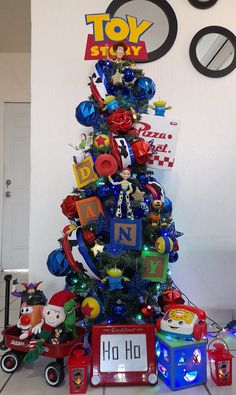 a christmas tree decorated with toys and letters