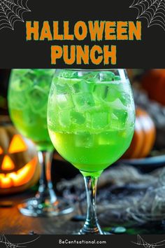 two glasses filled with green liquid next to pumpkins and jack - o'- lanterns