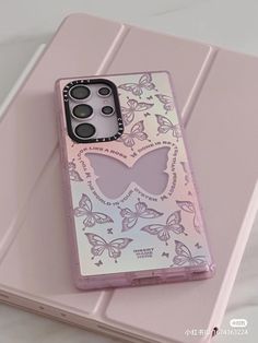 a pink phone case with butterflies on it