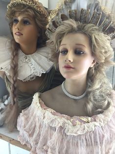 two mannequins are dressed up as princesses