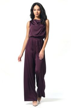 Off-the-shoulder jumpsuit with a halter neck tie. The back features a draped cutout. Wide-leg pants with an elastic waist, highlighted by a broad belt. This elegant piece is perfect for special occasions. Inseam length: 88 cm.   Made of Armani silk, 100% polyester. Chic Maxi Length Jumpsuits And Rompers With Elastic Waistband, Elegant Halter Neck Evening Jumpsuits And Rompers, Chic Evening Jumpsuit With Tie Back, Evening Jumpsuits And Rompers With Tie Back, Sleeveless Satin Jumpsuit Or Romper, Sleeveless Solid Color Satin Jumpsuits And Rompers, Sleeveless Satin Jumpsuits And Rompers, Sleeveless Satin Jumpsuit For Date Night, Sleeveless Tie Back Jumpsuit For Night Out